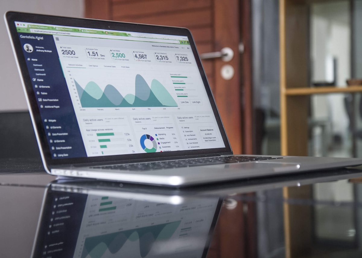 Laptop displaying lending software analytics and reporting